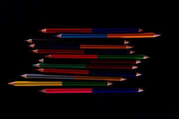 Wall Mural - collection of wooden colorful pencils on dark background, close view. High quality photo