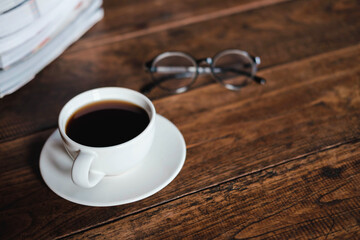 Wall Mural - Coffee cups and books placed on old wooden tables