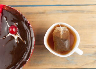 Poster - delicious cake with cherries and chocolate cream on wood table