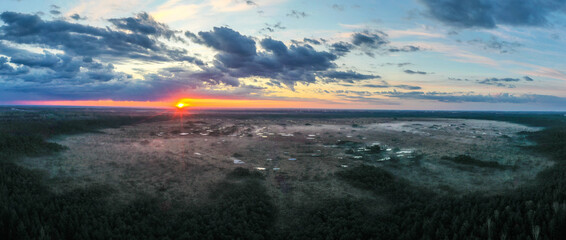 Canvas Print - Aerial view over lake rich peat bog in the sunrise foggy morning