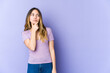 © Asier - Young caucasian woman isolated on purple background looking sideways with doubtful and skeptical expression.
