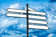 Blue white directional signs over cloudy sky