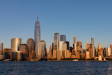 Fototapeta Nowy Jork - Lower Manhattan Skyline along the Hudson River in New York City Shining during a Sunset