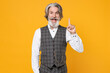 Excited elderly gray-haired bearded business man in checkered waistcoat shirt hold index finger up with great new idea isolated on yellow background studio portrait. Achievement career wealth concept.