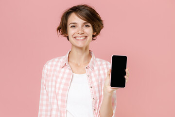 smiling young brunette woman wearing casual basic checkered shirt standing hold mobile cell phone wi