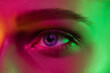 © master1305 - Eyes. Portrait of female fashion model in neon light on dark studio background. Beautiful caucasian woman with trendy make-up and well-kept skin. Vivid style, beauty concept. Close up.