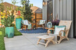 © Cavan Images - Outdoor patio with furniture behind luxury home