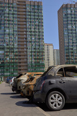 Wall Mural - city burned cars after a fire in one of the city's districts