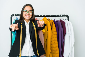 Wall Mural - Young asian designer woman isolated on white background cheerful smiles pointing to front.