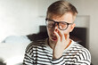 © Natallia - Tired man taking off glasses rubbing dry irritated eyes to relieve pain feeling discomfort suffers eye strain, poor blurry vision isolated on white background, organ of sight fatigue. Tiredness, pain