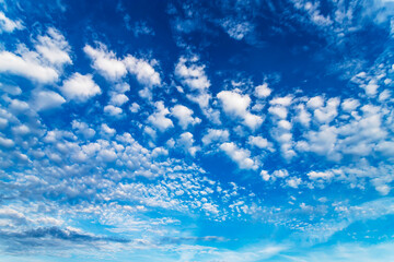 Blue sky with white clouds in sunny summer day.