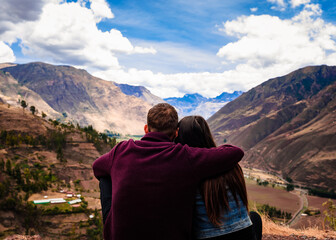 Couple with scenic view of the Sacred Valley from Mirador de Taray. Cusco, Peru 