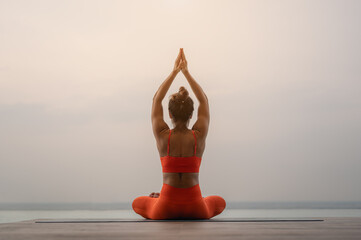 A woman doing yoga asana. Morning natural stretch warm-up training..Yoga,fitness and healthy lifestyle concept