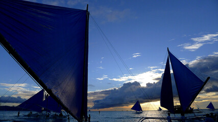 Small sailing boats at the sunset. Boracay, Philippines