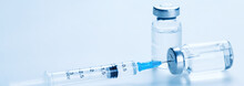 Medical Syringe With A Needle And A Bollte With Vaccine.