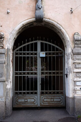 Poster - an old gateway with an iron gate. vertical frame