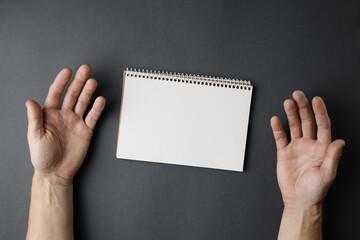 Wall Mural - Open notebook and male hands.