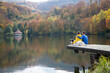 © Melinda Nagy - couple and dog sitting by beautiful autumn lake