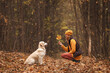 © finix_observer - Portrait of a young woman with a golden retriever dog in the autumn forest