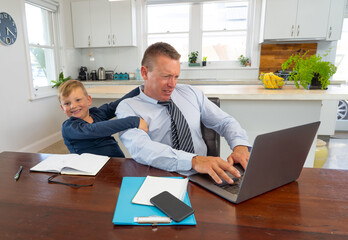 Wall Mural - COVID-19 school lockdowns and remote working. Stressed man trying to work from home with bored son