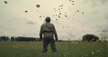 WW2 Solders Watch People Parachute Into Normandy, Low Angle