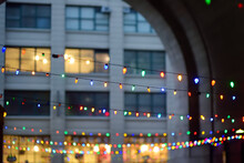 Photo Of Multicolored Garland Lights On Christmas Eve On Street Of Manhattan In New York.