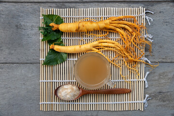 Wall Mural - Fresh Ginseng root with a cup of hot tea ,The concept of healthy drink