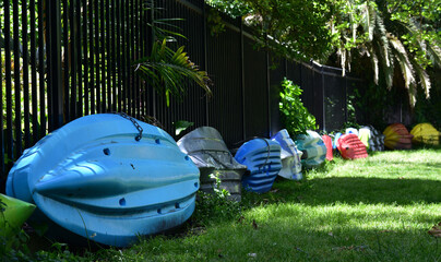 colorful small boats along the fence