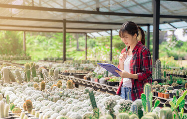 Beautiful smart farmer woman maintaining agriculture growth farming greenhouse plants researching taking care looking after science development cultivating analyzing flora nature natural vegetation