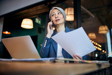 Wall Mural - Beautiful woman talking on mobile phone at work