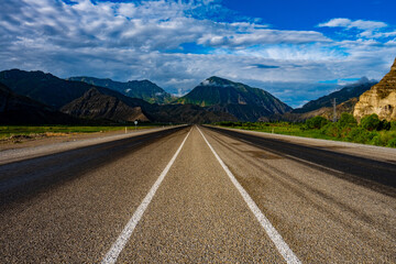 Poster - Beautiful shot of a road through the mountains in Uzundere, Erzurum, Turkey on a sunny day