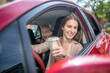 © zinkevych - Smiling mom holding coffee cup, driving with her amazed daughter