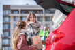 © zinkevych - Happy mom and daughter taking out present boxes from car trunk