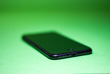 Black Phone On A Green Background