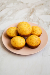 Wall Mural - Homemade Cornbread Muffins on a pink plate, side view.