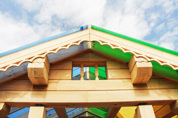 Construction of a house from a wooden beam. A fragment of the roof. Close-up.