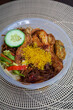 Nasi Ambeng or Nasi Ambang. It is a fragrant rice dish that consists of steamed white rice, chicken curry or chicken stewed in soy sauce, beef or chicken rendang, sambal goreng urap, bergedel.