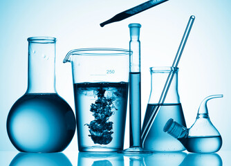 Wall Mural - different laboratory glassware with color liquid and with reflection
