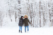 © satura_ - Happy loving couple having fun outdoors in snow park. Winter vacation