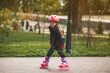 © Andrii Zastrozhnov - A cute little girl is rollerblading in the cold autumn weather in the park.