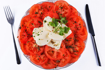 amazing delicious tomato salad with cheese and olive oil with greens