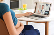 © Pixel-Shot - Young pregnant woman video chatting with doctor at home