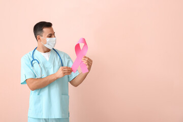 Wall Mural - Doctor with pink ribbon on color background. Breast cancer awareness concept