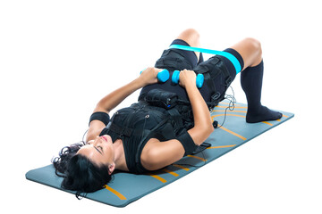 A young athletic woman in an EMS suit does an exercise on a dumbbell Mat on an isolated white background. EMS training. Electrical muscle stimulator.