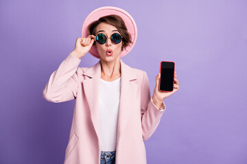 Photo of curly charming woman wear pink vintage jacket lips pouted hand arm glasses phone isolated purple color background