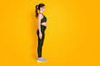 Full length body size profile side view of nice sportive healthy girl standing straight isolated over vibrant yellow color background