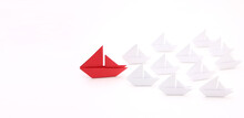 Red Paper Ship With Small Boats.Leadership Concept.