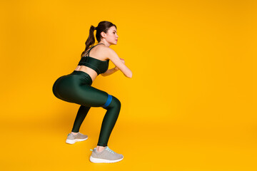 Photo of sporty lady butt workout stretch resistance rubber stripe wear sports suit isolated yellow color background