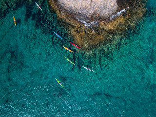 Wall Mural - Aerial view of canoes sailing near the rugged coastlines and beaches of Lanzarote, Spain, Canaries. Explore the island. Bathers on the beach and in the Atlantic Ocean. Papagayo