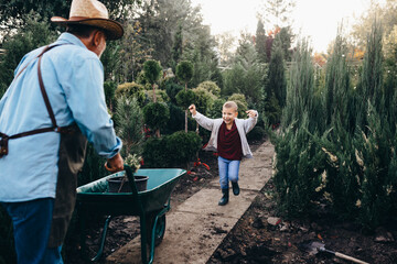 Wall Mural - the boy runs to hug his grandfather in evergreen nursery